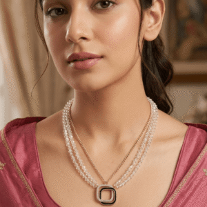 A beautiful Pakistani actress styling a layered gold and crystal bead necklace featuring an interlocking rhinestone and black enamel square pendant.
