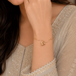 Elegant gold bracelet with heart charm for women.