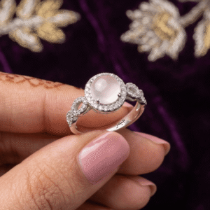 A beautiful Pakistani actress showcasing a silver plated rose quartz halo ring with a crystal paved twisted band on her finger.