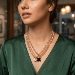 A beautiful Pakistani actress styling a multi-strand layer necklace made of champagne crystal beads and fine gold chain holding a black clover pendant.