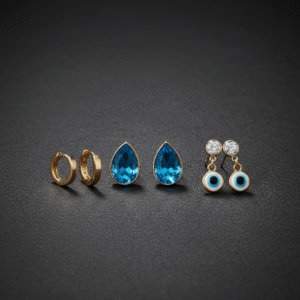 Three pairs of gold and blue earrings from Gems and Jewells on a black background.