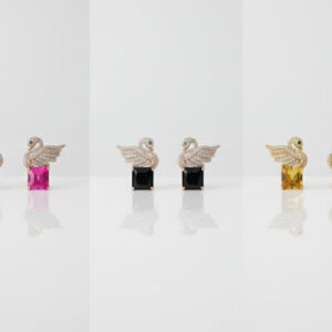 A multi-color collection of premium gold crystal swan earrings with large blue, pink, black, yellow, and green square gemstones.