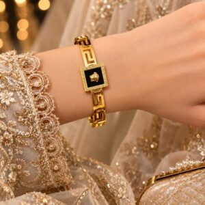 Silver gold-plated Medusa bangle with black enamel design.