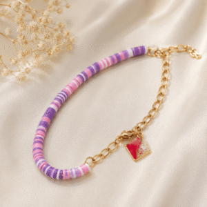 Silver purple beaded bracelet with gold charm.