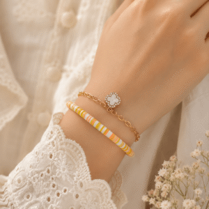 Model wearing silver orange beaded bracelet with clover charm.