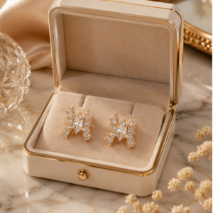 Elegant gold crystal stud earrings featuring a marquise-cut center stone with sparkling pavé detailing for women.