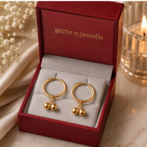 Minimalist gold hoop earrings featuring polished double ball accents for women.