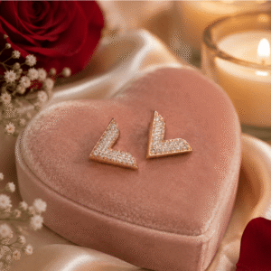 Elegent gold stud earrings with sparkling cubic zirconia stones displayed on a pink heart-shaped velvet jewelry box.
